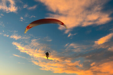 motor paraglider in the sunset
