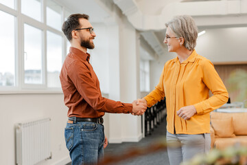 Team smiling confident business people handshake  working together in modern office. Meeting,...