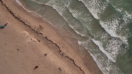 Fototapeta na wymiar Minimalistic aerial view of a the sandy beach with splashing waves of the sea