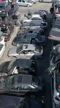Vertical Video of Old Car Junkyard with the Pile of Old Damaged Cars