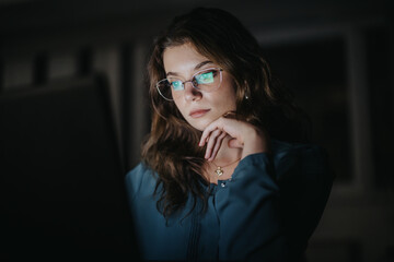 Female person working late at night. She is giving it all to grow his small business.