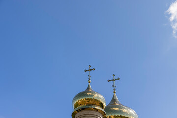 wooden christian cross on a blue sky background