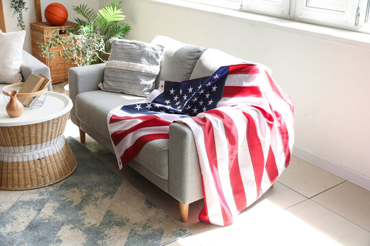 Interior of stylish living room with USA flag on sofa