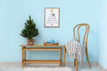 Interior of living room with Christmas calendar, chair and table