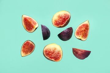 Pieces of fresh ripe figs on turquoise background
