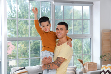 Young man with his little son at home