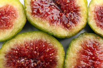 Pieces of fresh green figs on table, top view