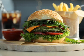 Tasty vegetarian burger served with french fries and soda drink on white table, closeup