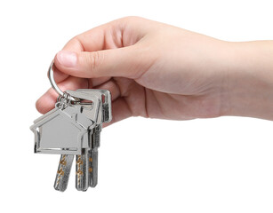 Woman holding keys with keychain in shape of house isolated on white, closeup