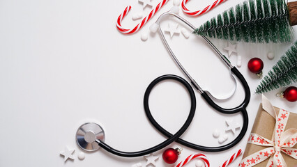 Christmas medical banner.Stethoscope,gift box,decorative Christmas trees,red balls,stars and pills...