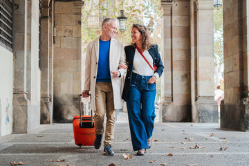 Portrait of a happy mature couple sightseeing on a romantic journey trip in Spain. Middle aged...