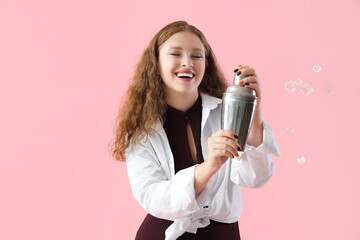 Female bartender with shaker on pink background