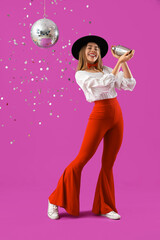 Female bartender with shaker and disco ball on purple background