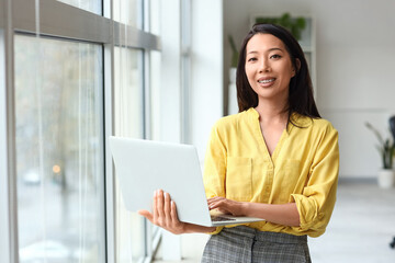 Asian businesswoman working with laptop in office