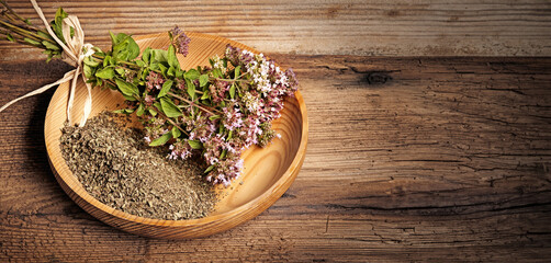 Obraz na płótnie Canvas Origanum vulgare (oregano) herb - spice on a table