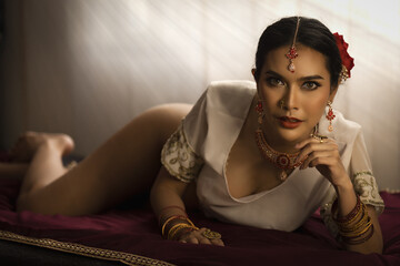 elegant woman adorned in traditional Indian attire posing gracefully