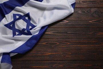 Flag of Israel on wooden background, top view and space for text. National symbol - obrazy, fototapety, plakaty