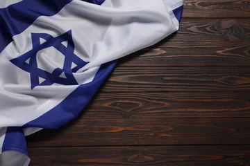  Flag of Israel on wooden background, top view and space for text. National symbol © New Africa