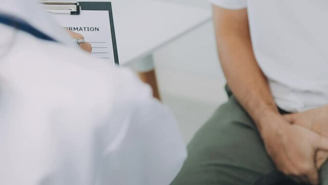 Man with benign prostatic hyperplasia being examined and consulting Asian female doctor and The doctor will ask about the patient's illness and give health advice.