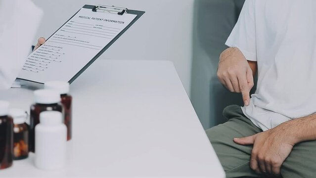 Man with benign prostatic hyperplasia being examined and consulting Asian female doctor and The doctor will ask about the patient's illness and give health advice.