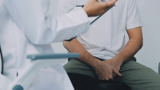 Man with benign prostatic hyperplasia being examined and consulting Asian female doctor and The doctor will ask about the patient's illness and give health advice.