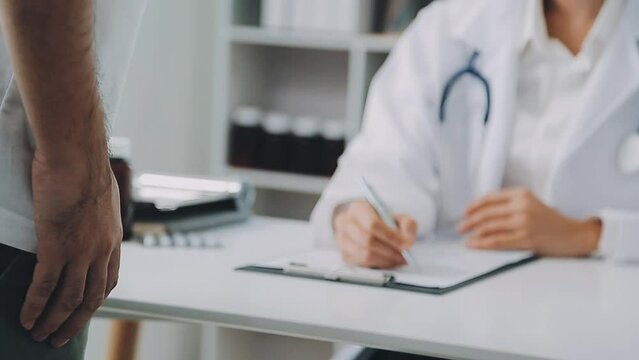 Doctor prescribes treatment to patient with bowel problems and model of unhealthy lower rectum