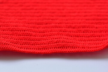 red wool knitted yarn texture, woolen fabric on white background
