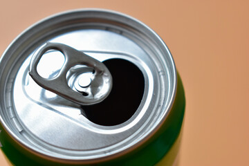 aluminum green drink cans on orange background, open cold fresh beverage