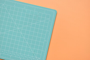 green cutting mat on orange background, object tool for design