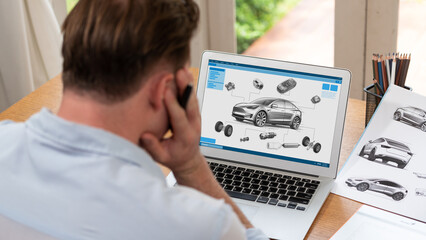 Obraz na płótnie Canvas Car design engineer analyze car prototype for automobile business at home office. Automotive engineering designer carefully analyze, finding flaws and improvement for car design with laptop Synchronos