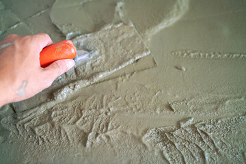 Mechanical man hand plaering cement interior floor building