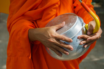Buddhist monks carrying their alms bowls in southern Vietnam. - obrazy, fototapety, plakaty