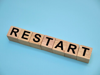 Restart, text written on wooden block, business term