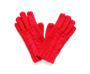 Red knitted gloves on white background