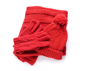 Red knitted gloves with warm scarf and hat on white background