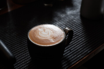 latte art making process in cafe background