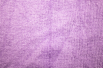 Authentic texture of microfiber, fabric, rag. Purple fabric background.