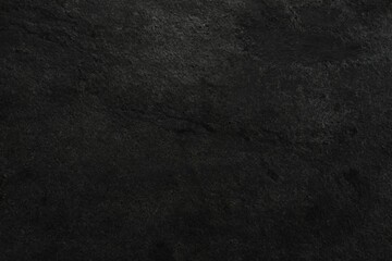 Texture of dark grey stone surface as background, closeup