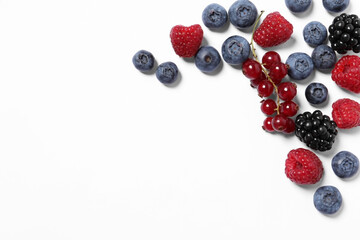 Many different fresh berries on white background, flat lay. Space for text