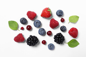 Many different fresh berries and mint leaves on white background, flat lay