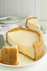 Tasty vegan tofu cheesecake on white table