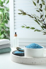 Blue sea salt on white table indoors, space for text