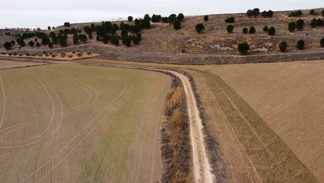Hiking in spain lonely. Drone footage in Castilla la Mancha, land of don quijote, vineyards, flat land, cereals, dirt tracks and paths. Horcajo de Santiago in 4K with DJI Mini 2