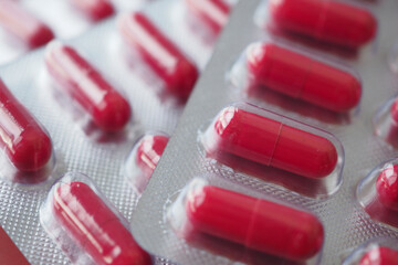 closeup of Red capsules on table 