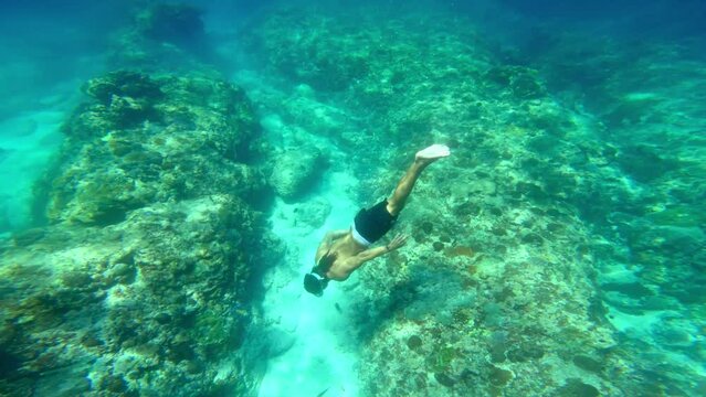 Man Snorkeling Swimming in Blue Sea Underwater. Freedive in Ocean Water with One Guy. Snorkeling and Diving in Deep Sea. Marine Life in Shallow Water. Person Swimming Near Coral Reef in Slow Motion 4k