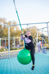 A girl is playing on the playground.