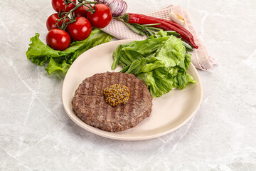 Frilled beef burger cutlet with iceberg
