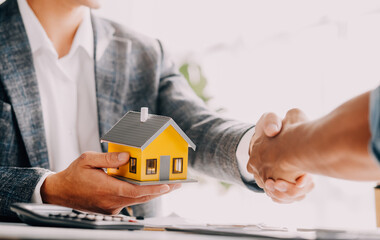 Real estate agent and customer signing contract to buy house, insurance or loan real estate.rent a house,get insurance or loan real estate or property.