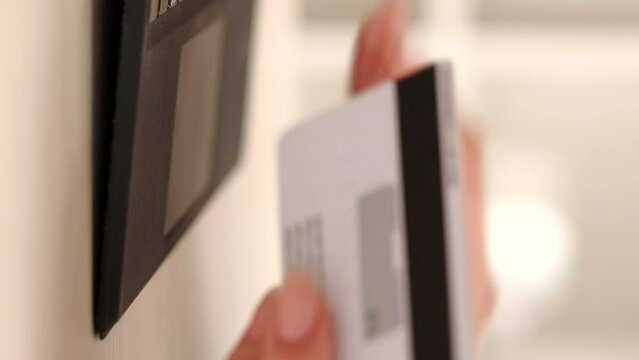 Vertical video. Online payment. Internet banking. Business woman with credit card in hand typing personal data cvv code on laptop for cashless money transfer purchase.