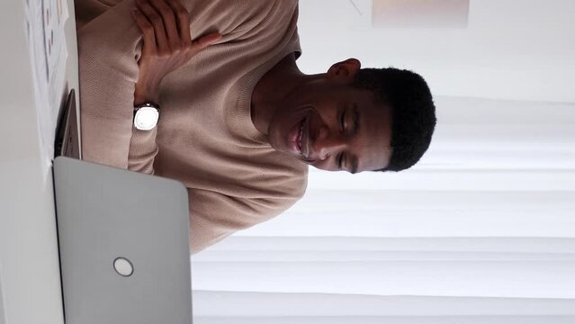 Vertical video. Online coach. Internet call. Business communication. Cheerful man employee discussing corporate project at laptop virtual meeting conference at office workplace.